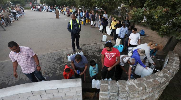 People queue to collect water as fears over the city's water crisis grow in Cape Town